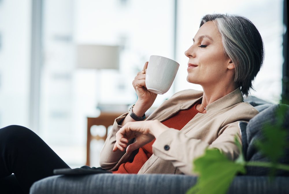 relaxed woman sipping a cup of coffee